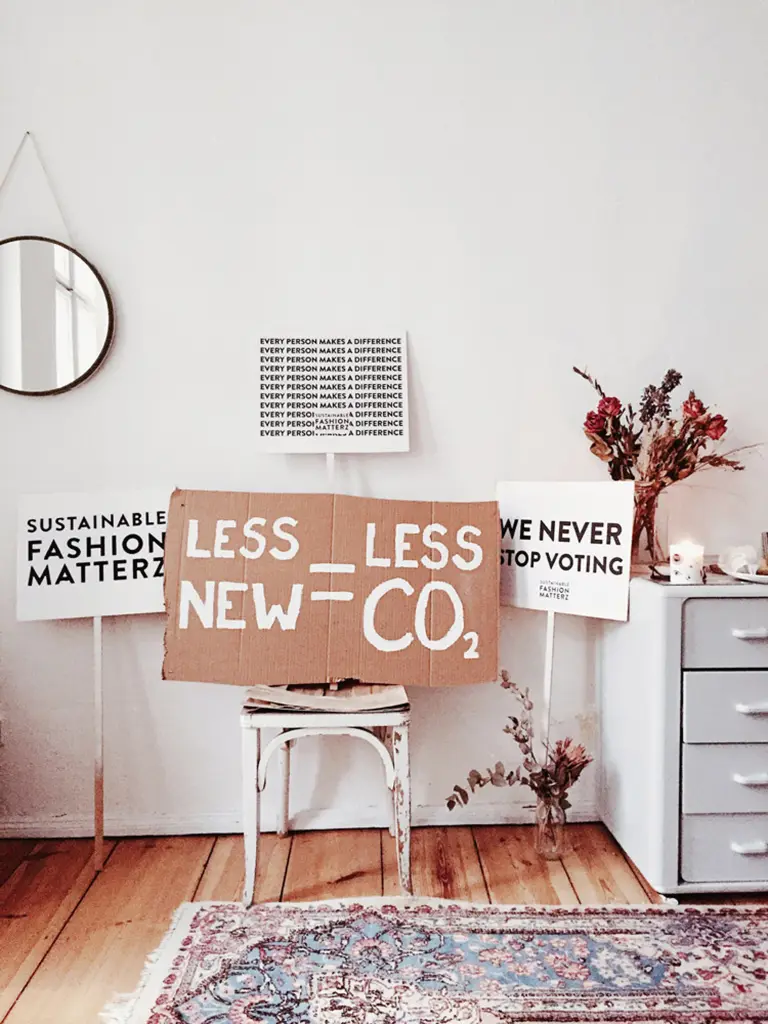 placards calling for sustainable shops, sustainable stores and sustainable fashion, bringing forwards the effect of mindless consumption on the environment